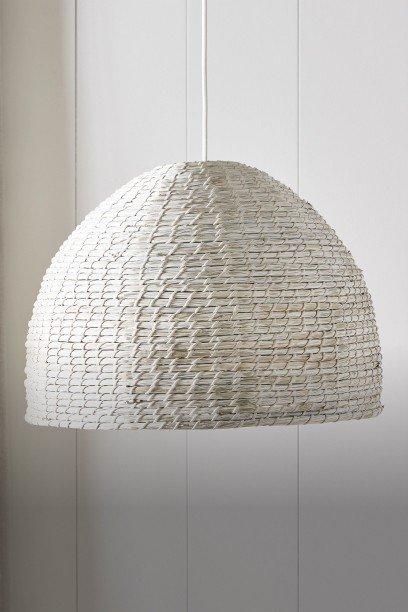 a white light hanging from a ceiling in a room