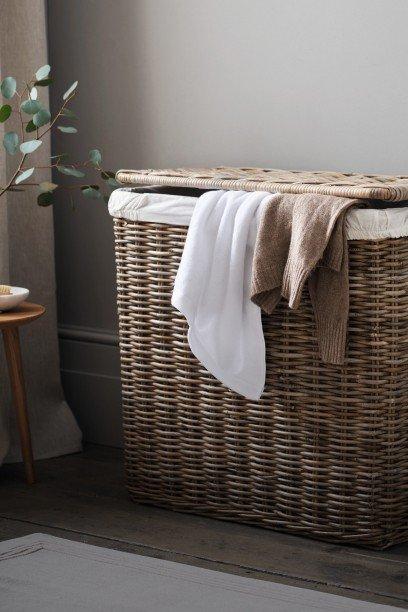 a wicker laundry basket with a towel and a towel on top