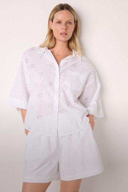 a woman in white shorts and a white shirt