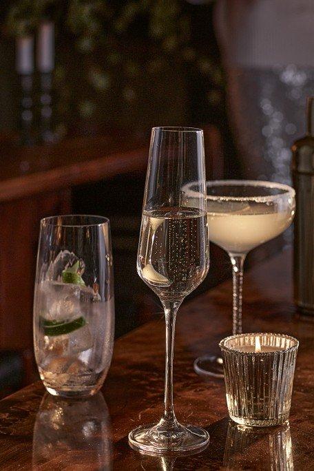 a bar with several glasses and a candle on a table