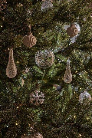 a close up of a christmas tree with ornaments on it