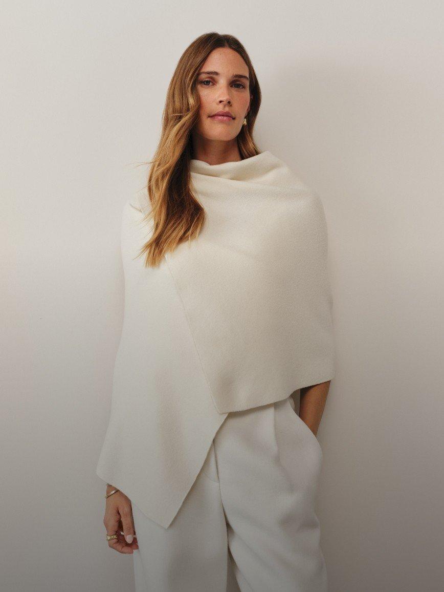 a woman in white is posing for a photo