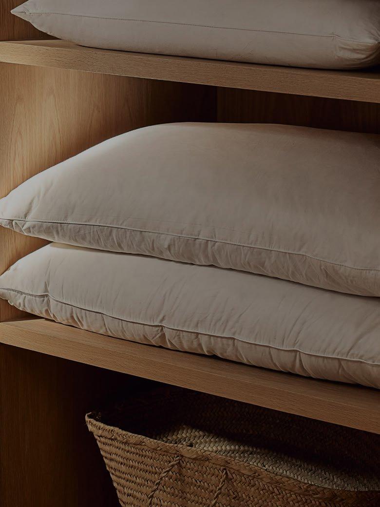 a wooden shelves with pillows and blankets on them in a room