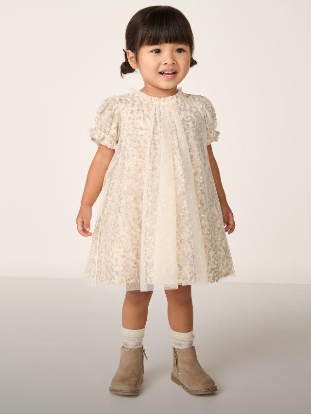 a baby wearing a dress