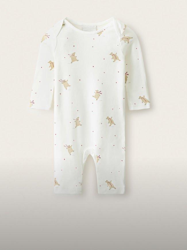 a white baby romper with a cat print on it