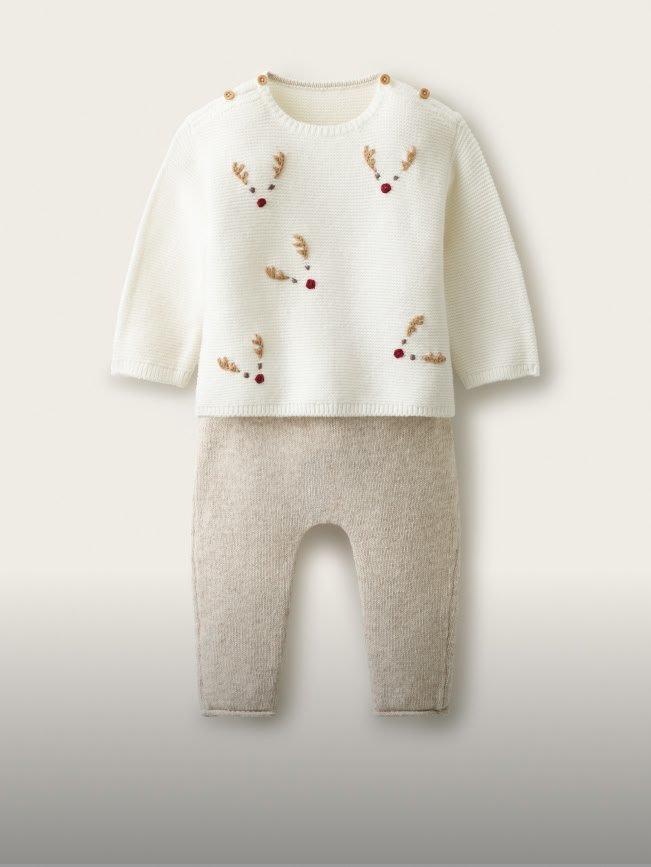 a baby sweater and pants set with reindeer on it