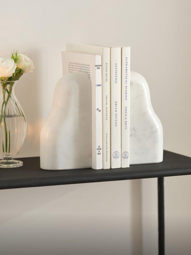 a vase of a vase of flowers and a book on a table