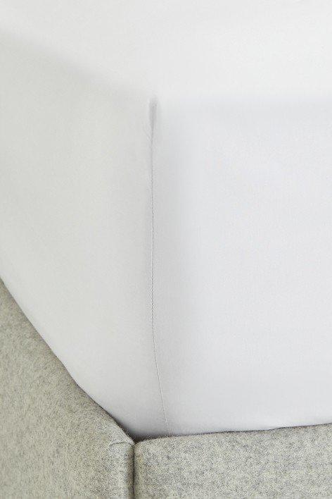 a close up of a pile of white pillows on a bed