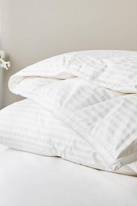 a bed with a white headboard and footboard in a bedroom