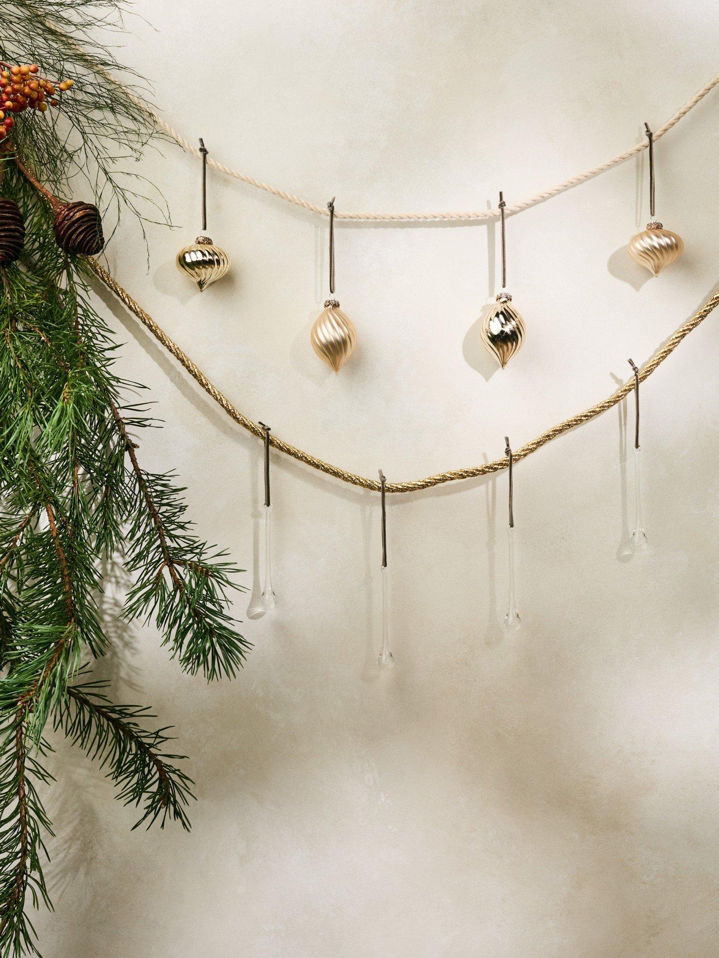 a string of ornaments hanging from a tree branch