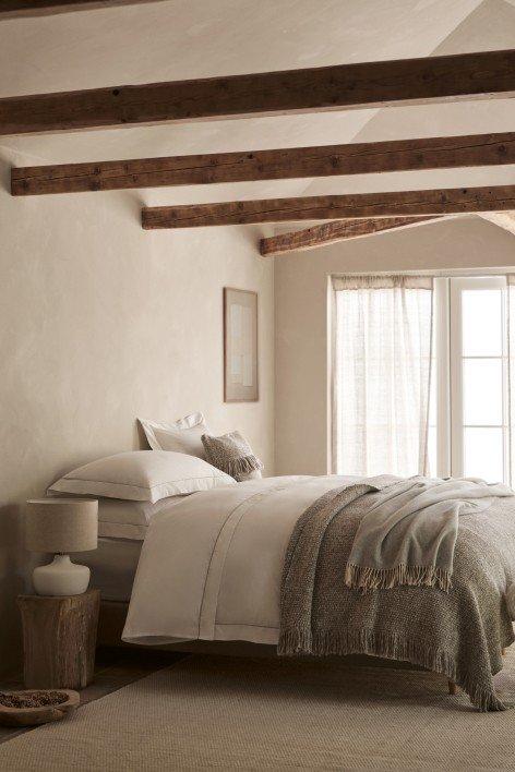 a bedroom with a bed, a dresser, and a window