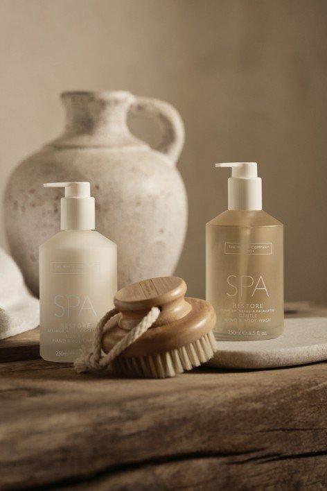 a wooden table with a bottle of soap and a brush