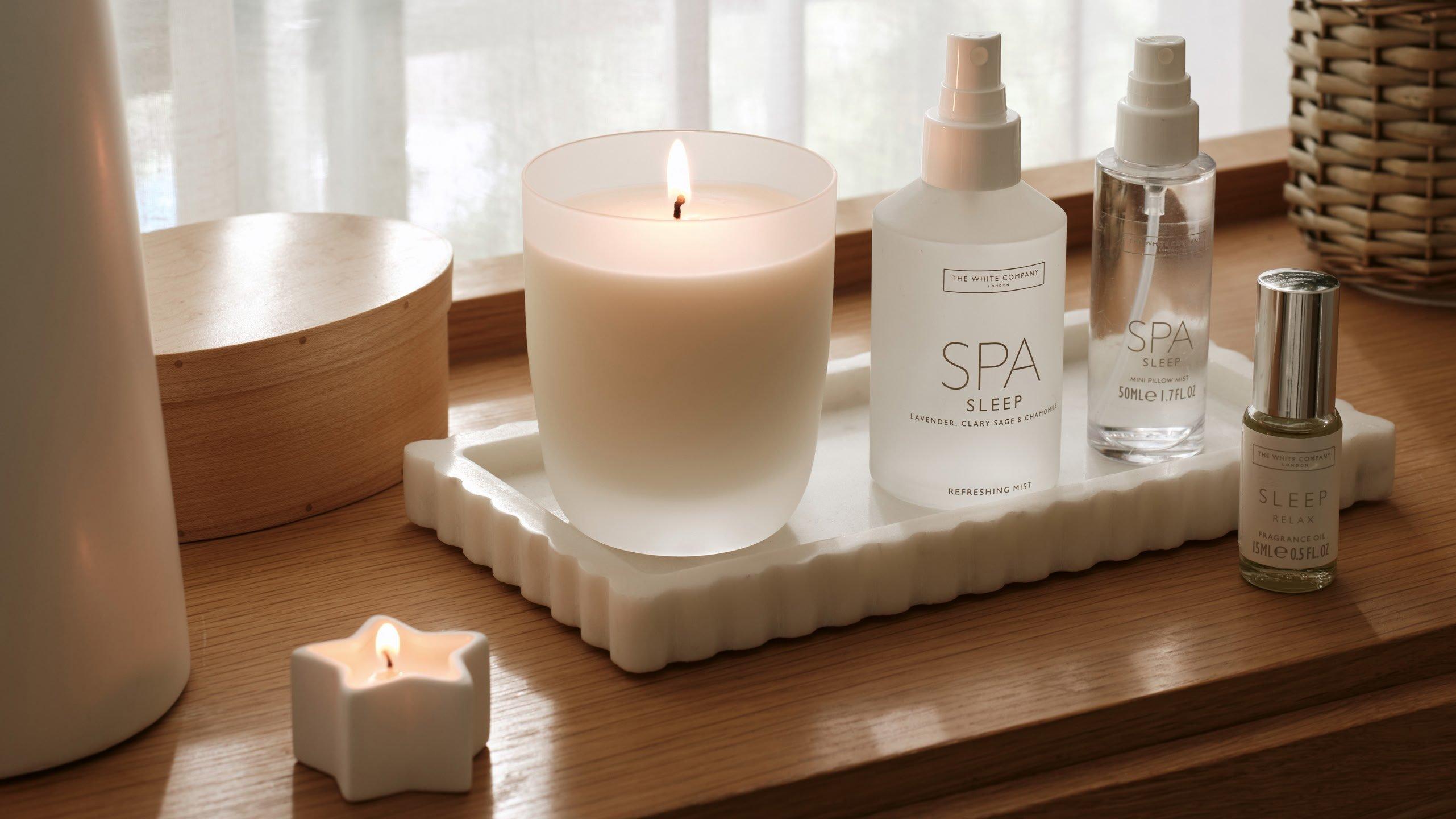 a tray with wellness candles and spray