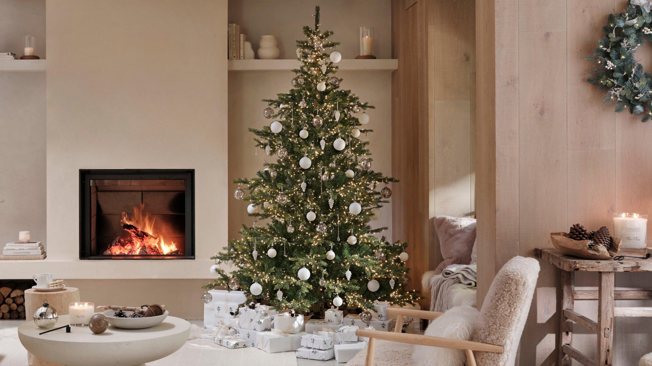 a living room with a fireplace and a christmas tree