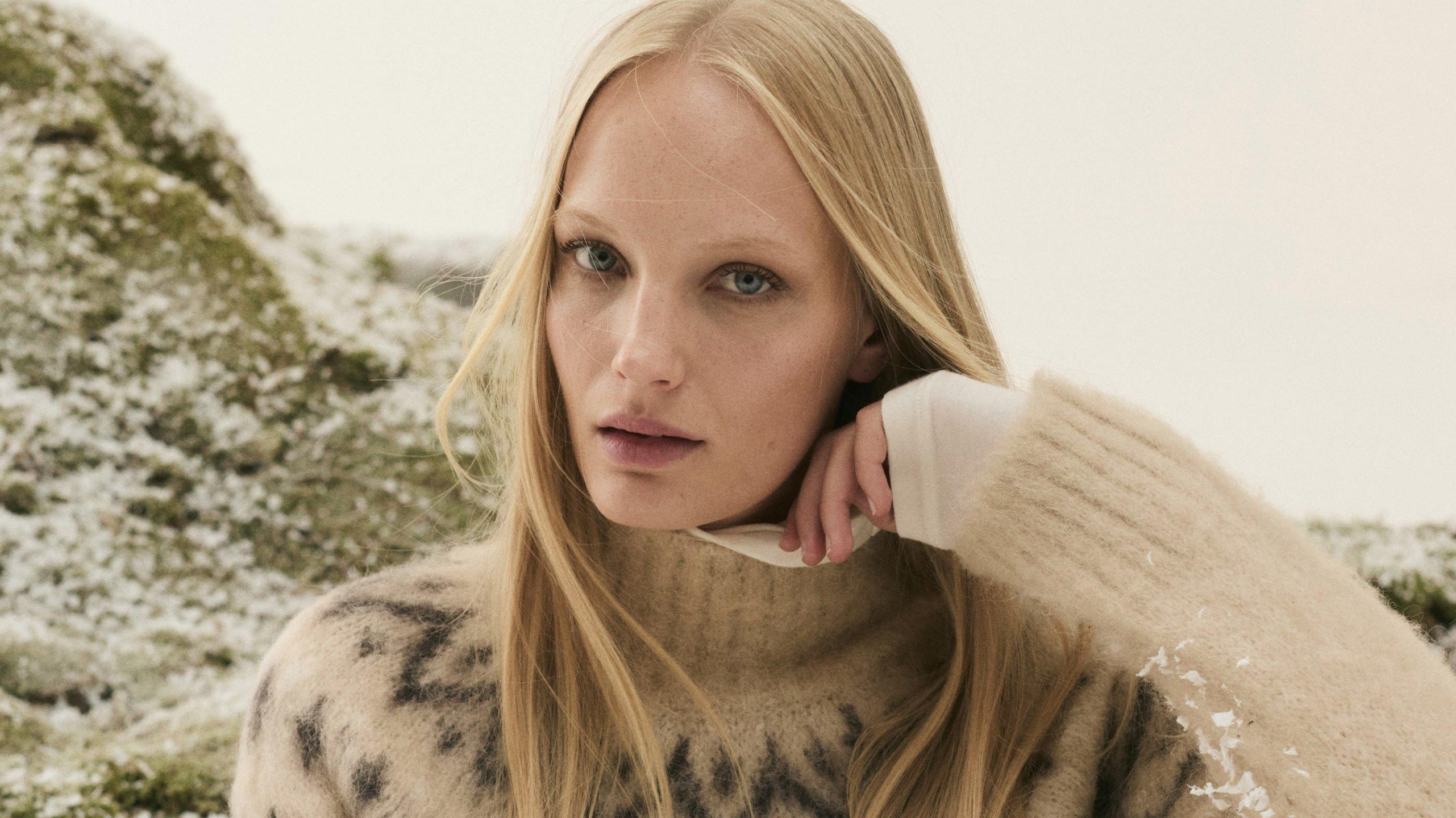 a woman in a cashmere roll neck jumper