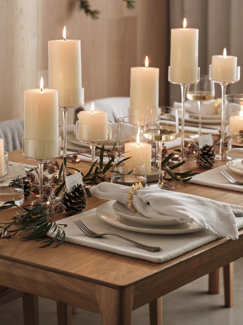 a table with candles and plates and silverware on it