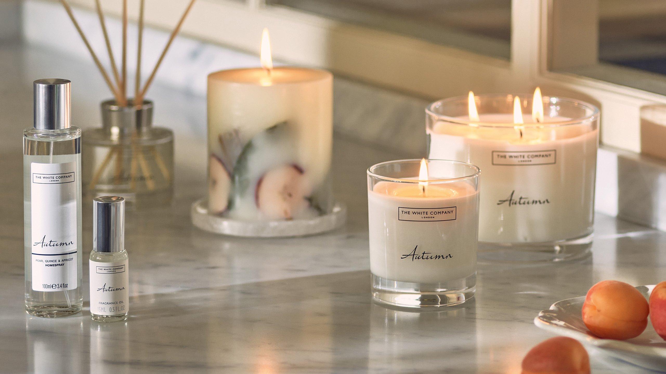 a counter with candles, fruit and a glass of water
