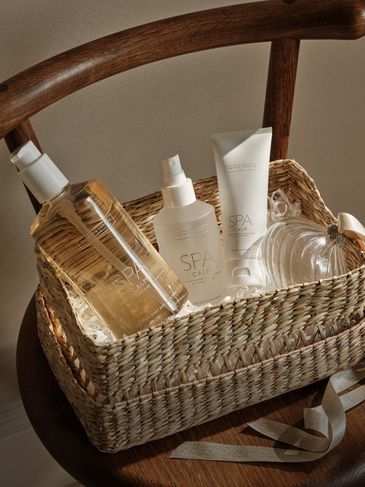 a basket with a bottle of lotion and other items on a chair
