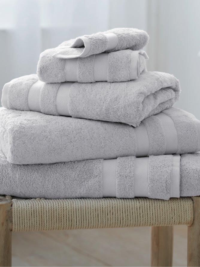 a stack of towels on a stool in a room