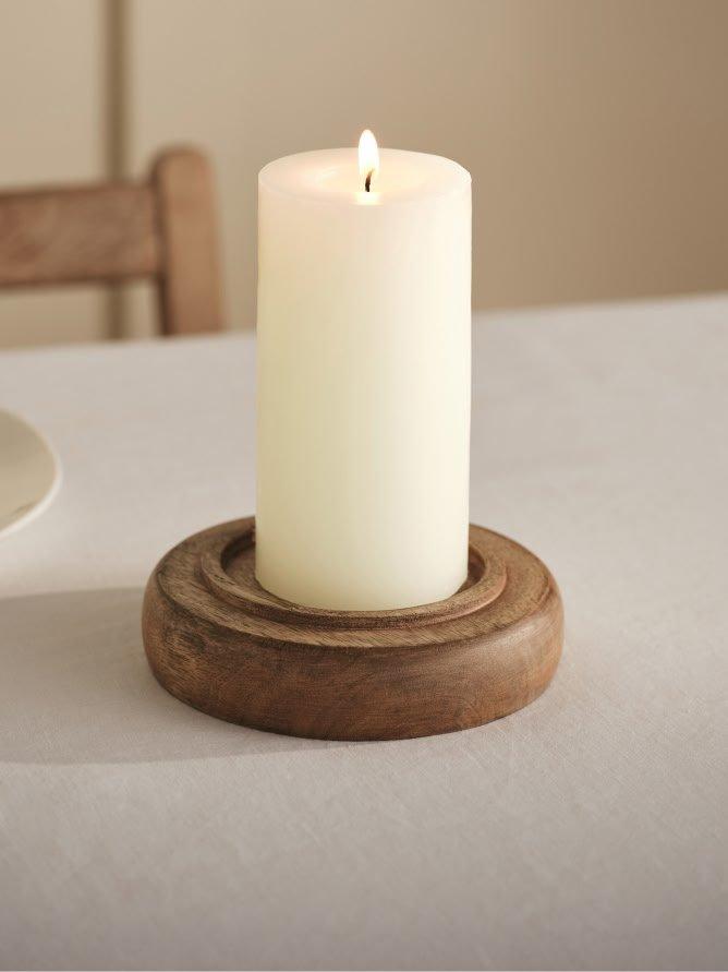 a candle sitting in a glass dome on a table