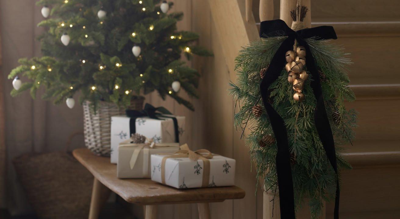 a table with a candle, ornaments and a box of ornaments